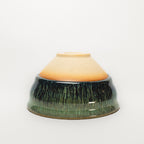 Ceramic tea cup with two-tone design on a white background