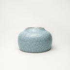 Light blue ceramic tea cup on a white background