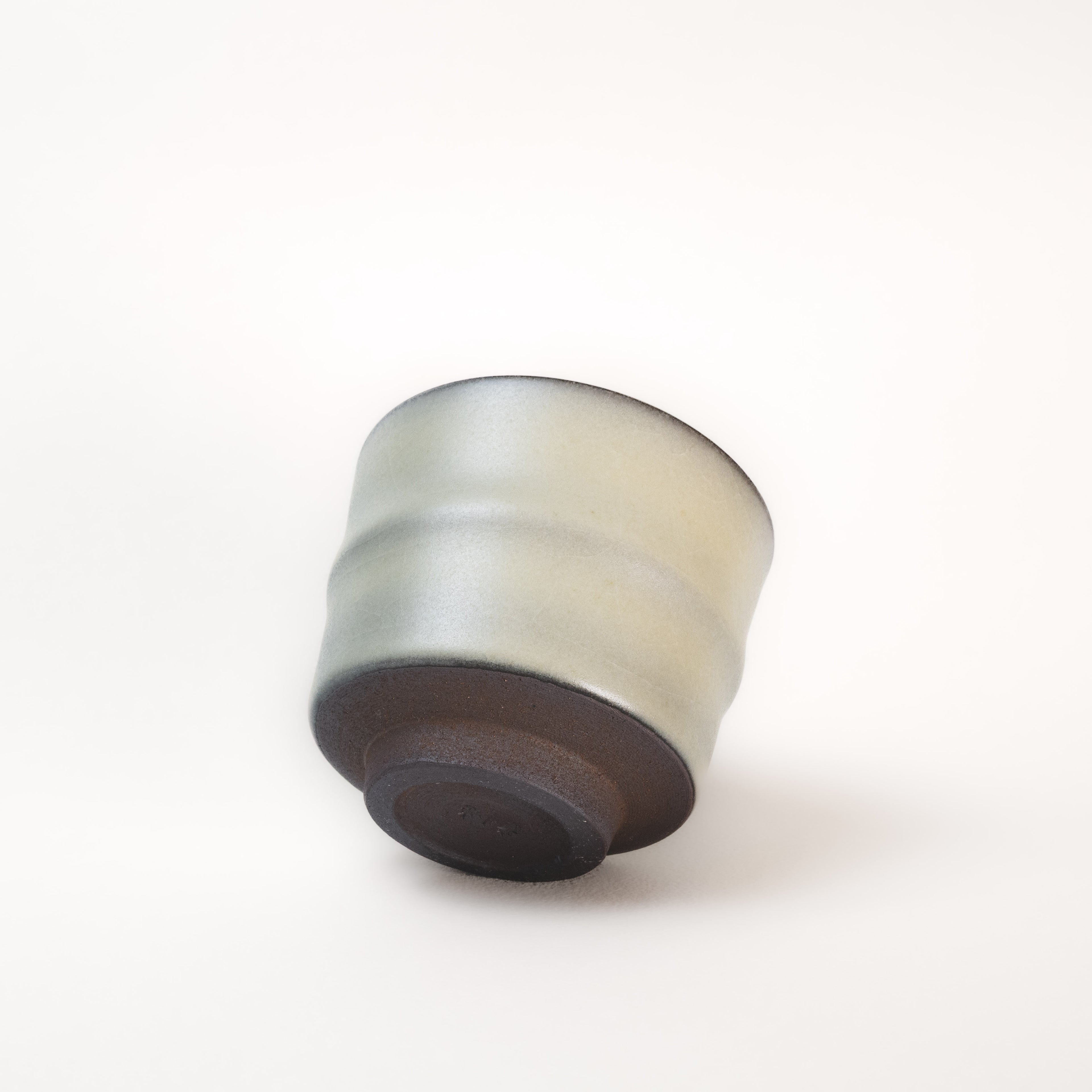 Round ceramic tea cup with a gradient color on a white background