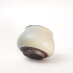 Round ceramic tea cup with two-tone color on a white background