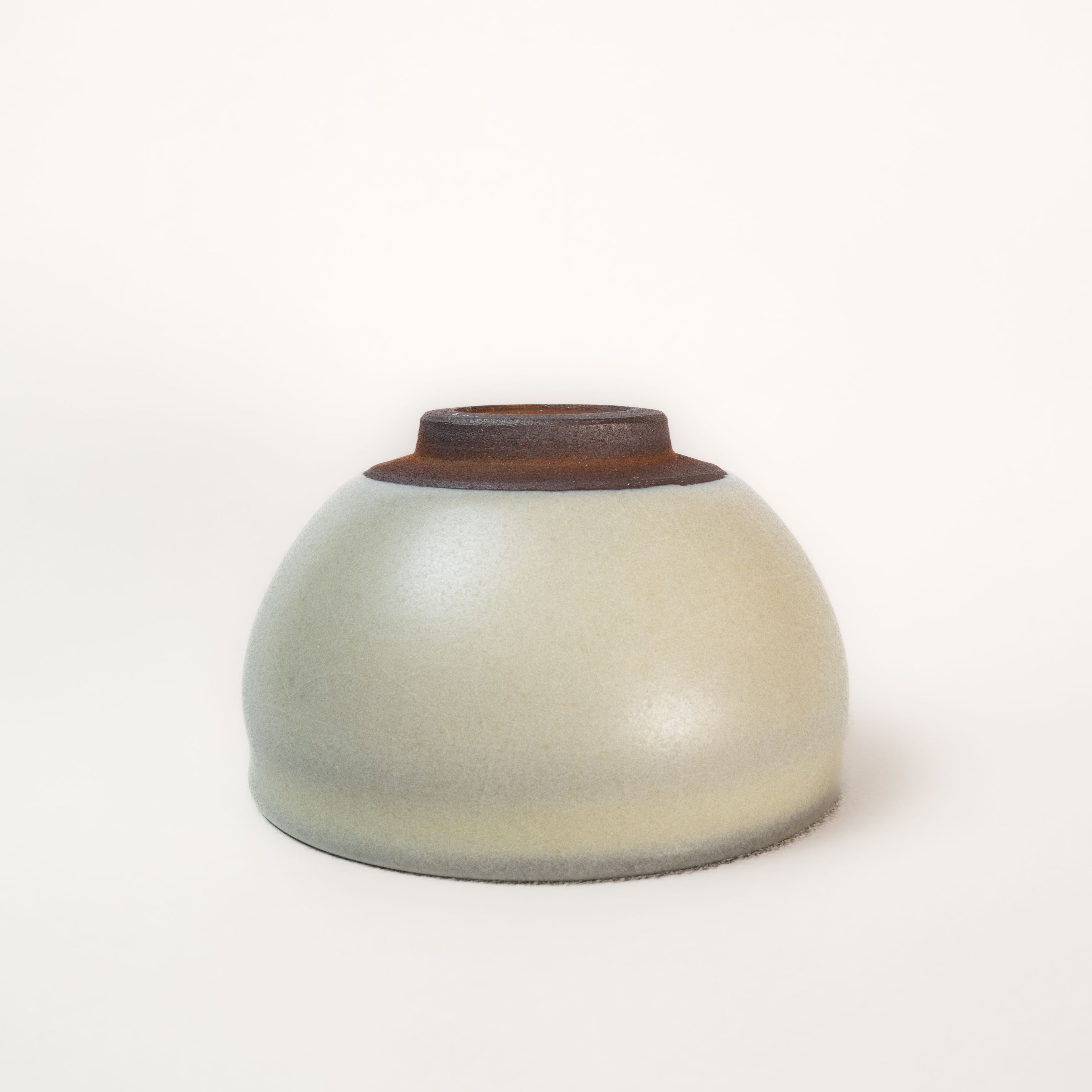 Ceramic cup with a brown rim on a white background