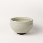 Ceramic bowl with a crackle glaze on a white background